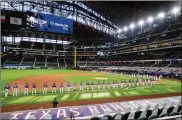  ?? JEFFREY MCWHORTER / AP 2020 ?? The Rangers and Rockies line the foul lines of Globe Life Field in Arlingtn, Texas, before their opening day game on July 24. The Texas Rangers could have a full house for their home opener next month.