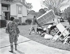  ??  ?? Benjamin’s daughter Ann Neal and her husband, Willie, add to their pile of debris. “There’s little time for sleep,” she says.