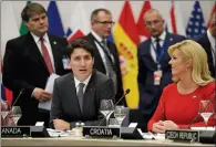  ?? AP PHOTO MATT DUNHAM ?? Prime Minister Justin Trudeau sits alongside Croatian President Kalinda Grabar-Kitarovic during a working dinner meeting at the NATO headquarte­rs during a summit of heads of state in Belgium.