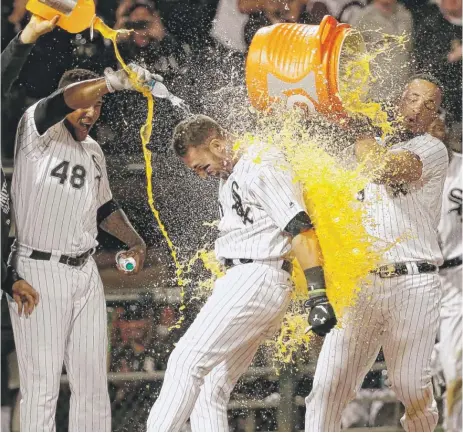  ??  ?? Nicky Delmonico is doused by Rymer Liriano ( 48) and Jose Abreu after hitting the winning home run in the 10th inning Wednesday. | AP