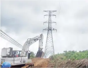  ?? ?? Reconstruc­tion of a vandalised power line near, Uyo recently