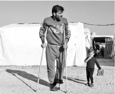  ??  ?? File photo shows a Syrian refugee walks on crutches at a refugee camp in Akkar, northern Lebanon. — Reuters photo