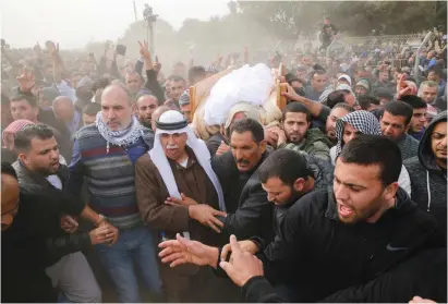  ?? (Ammar Awad/Reuters) ?? Washington FRIENDS AND RELATIVES carry the body of Yacoub Abu al-Kiyan during his funeral in the Beduin village of Umm al-Hiran on Tuesday.