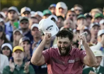  ?? Associated Press ?? Jon Rahm, of Spain, celebrates on the 18th green after winning the 2023 Masters golf tournament at Augusta National Golf Club in Georgia.