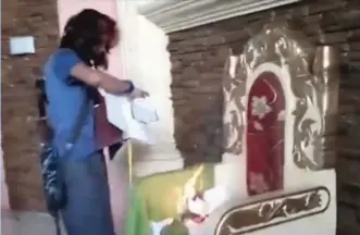  ??  ?? Screen pictures from an ISIS propaganda video show desecratio­n of church.