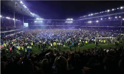  ?? Photograph: Oli Scarff/AFP/Getty Images ?? Everton's fans invade the pitch and let off smoke bombs after the club avoided relegation in May.