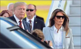  ?? Schreiber / AP Markus ?? U.S. President Donald Trump, left, and his wife Melania arrive at the airport in Helsinki, Finland on Sunday on the eve of his meeting with Russian President Vladimir Putin.