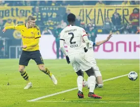  ??  ?? Dortmund’s Erling Braut Haaland, left, scores against Frankfurt.