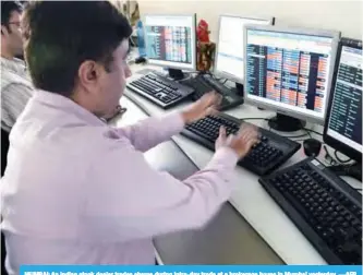  ??  ?? MUMBAI: An Indian stock dealer trades shares during intra-day trade at a brokerage house in Mumbai yesterday. —AFP