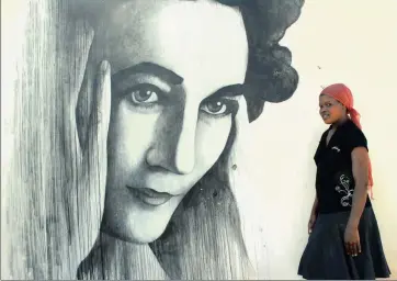  ?? PICTURE: GIYANI BALOI ?? BREAKING BARRIERS: Beauty Mlakalaka next to a painting of activist Ruth First at her Soweto house. One of the themes of the Ruth First Lecture at Wits tonight is interracia­l friendship­s in a post-apartheid SA.