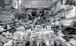  ?? PICTURE: REUTERS ?? HARD TIMES: A vendor in her shop in a market in Beijing this week. China’s consumer inflation quickened in last month due to rising food prices while producer prices declined for a 47th straight month, as falling commodity prices and weak demand add to...