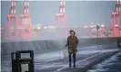  ?? Photograph: Christophe­r Furlong/Getty Images ?? A woman tries to avoid sea spray, whipped up by the wind and waves on Brighton promenade, as the UK readies for the arrival of Storm Barra.