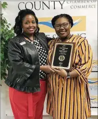  ??  ?? Jackie Lawson, left, representi­ng Bank OZK, presents the Young Person of the Year Award to Asijah Yarbrough, a senior at Malvern High School.