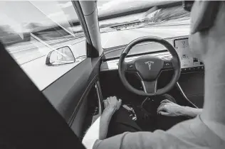  ?? Dreamstime / Tribune News Service ?? Tesla tells drivers to keep their hands on the steering wheel in Autopilot and Full Self-Driving modes. Consumer Reports tricked a Tesla to drive on Autopilot with nobody in the driver’s seat.