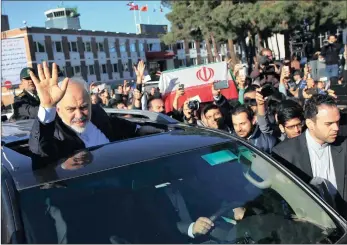  ?? PICTURE: AP ?? GOOD NEWS: Iranian foreign minister Mohammad Javad Zarif, who is also the country’s top nuclear negotiator, waves to well wishers upon arrival at the Mehrabad airport in Tehran from Lausanne, Switzerlan­d, yesterday.