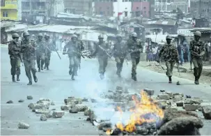  ?? PICTURE: AP ?? Security forces chase supporters of Kenyan opposition leader and presidenti­al candidate Raila Odinga, who were demonstrat­ing in the Mathare area of Nairobi yesterday.