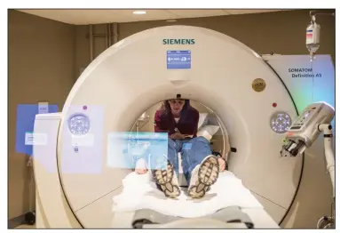  ?? Michael Henninger/The Washington Post ?? Kim Ralston, a CT technologi­st, prepares Bob Croft for a neck scan at the Allegheny Health Network’s health center in Wexford, Pennsylvan­ia, on Feb. 2.