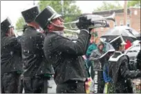  ??  ?? Trumpeter hitting a high note in the rain during the Veterans of Lansingbur­gh 21st annual Memorial Day Parade.