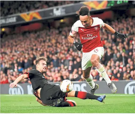  ??  ?? Going all out: Rennes’ Damien Da Silva vying for the ball with Arsenal’s Pierre-Emerick Aubameyang during the Europa League last 16, second-leg match at the Emirates on Thursday. — Reuters