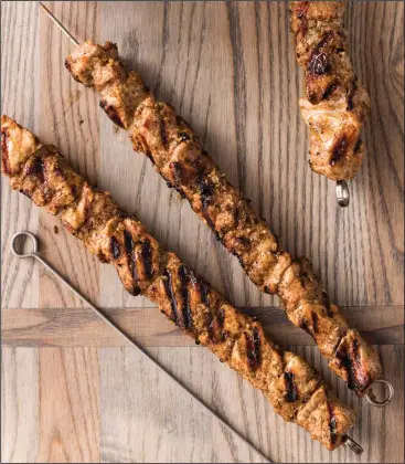  ?? Joe Keller/America’s Test Kitchen via AP ?? Grilled Spiced Pork Skewers with Onion and Caper Relish, from “The Complete Diabetes Cookbook.”