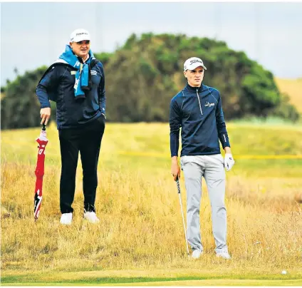  ??  ?? Masterclas­s: Scotland’s Sam Locke takes some tips from former Open champion Paul Lawrie at Carnoustie