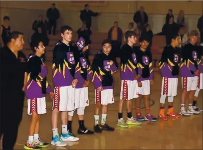  ?? PHOTOS COURTESY OF TRETT BISHOP ?? Decked out in Lakers colors, members of the Upper Lake High School varsity boys basketball team paid tribute to Lakers superstar Kobe Bryant before their league home game against Credo nearly a year ago today. Bryant died in a helicopter crash two days earlier.