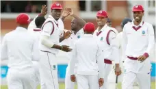  ?? — Reuters ?? West Indies’ Kemar Roach celebrates the wicket of England’s Moeen Ali with team-mates during the third Test against England.