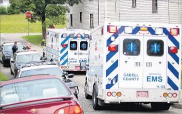  ?? Lori Wolfe Herald-Dispatch ?? POLICE AND emergency workers respond to overdose calls this month in Huntington, W.Va. Twenty-six people overdosed, two fatally, on a potent batch of heroin. There are just 28 beds in state detox programs.