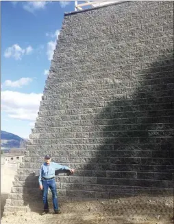  ?? Okanagan Weekend file photo ?? In this April 2018 file photo, Hugo Deuschle stands beside a wall that was built on his property line, without his knowledge.