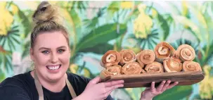  ??  ?? Electoral rolls . . . Blend Espresso’s Helena Findlay (24) shows some of the cheese rolls Judith Collins missed out on after failing to turn up to the Mosgiel cafe yesterday.