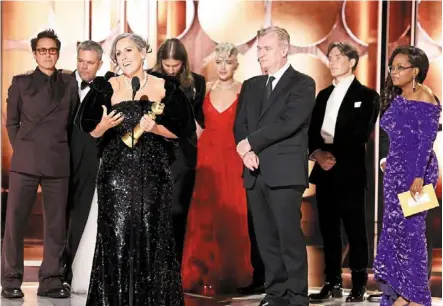  ?? — ap ?? We did it: Thomas accepting the award for best motion picture drama for ‘Oppenheime­r’ as cast and crew members look on.