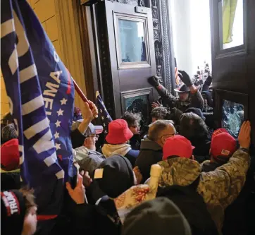  ?? WIN MCNAMEE Getty Images ?? A mob supporting President Donald Trump breaks into the Capitol on Wednesday in Washington, D.C.