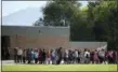  ?? KRISTIN MURPHY — THE DESERET NEWS VIA AP ?? In this Sept. 11, 2014 file photo, students line up to go back inside after recess at Westbrook Elementary School in Taylorsvil­le, Utah. Earlier in the day, schoolteac­her Michelle Montgomery was injured by fragments from a bullet and a porcelain toilet...