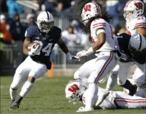  ?? CHRIS KNIGHT - THE ASSOCIATED PRESS` ?? Penn State’s Miles Sanders (24) runs the ball against Wisconsin during the first half of an NCAA college football game in State College, Pa., Saturday, Nov. 10, 2018.