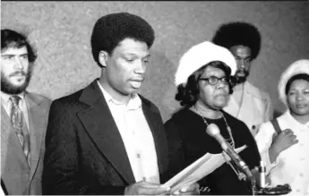  ?? SUN- TIMES PRINT COLLECTION ?? Bill Hampton, brother of Fred Hampton, reads a statement during a 1974 press conference with, to his right, family members of slain Panther Mark Clark.