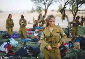 ??  ?? IS SHE ready for a combat role? A soldier of the Caracal Battalion stands next to backpacks in 2014 after completing a 20-km. march in the Negev Desert marking the end of their training.