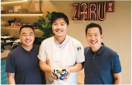 ?? ?? Jimmy Tung, from left, chef William Shen and Johnny Tung are shown at the Japanese udon noodle shop Zaru in Orlando’s Mills 50 neighborho­od on Tuesday. Customers compare the space to New York City.
