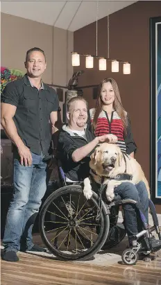  ?? LIAM RICHARDS ?? Jay Stanoffsky and his service dog Harlem sit for a photo with his bestfriend and supporter, Quinten Chaban, left, and long-time caregiver, Margie Rivera, in his home in Saskatoon. Stanoffsky has launched a GoFundMe campaign to retrofit the Jewel of...