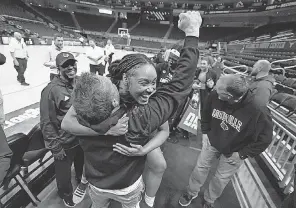 ?? ERIC GAY/ AP ?? Guard Chrislyn Carr, center, celebrates with Cardinals fans after Louisville’s win over Texas on Monday.