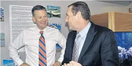  ?? MARK LONG/AP ?? UF athletics director Scott Stricklin smiles as he talks to Dan Mullen after his 2017 arrival at the airport in Gainesvill­e to become the Gators’ new football coach.