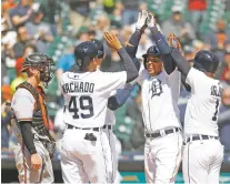  ?? PAUL SANCYA/THE ASSOCIATED PRESS ?? The Tigers’ Leonys Martin, third from left, celebrates his first grand slam Thursday in Detroit against the Orioles. The Tigers won 13-8.