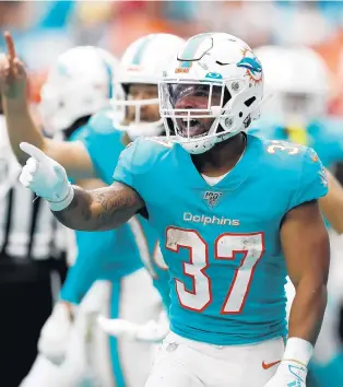  ?? BRYNN ANDERSON/AP ?? Dolphins running back Myles Gaskin gesture toward the sidelines after scoring a touchdown against the Bengals on Dec. 22, 2019, in Miami Gardens, Fla.