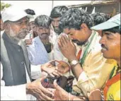  ??  ?? ■ Social welfare minister H Anjaneya (left) during a campaign in Holalkere, Karnataka, on Friday. ARIJIT SEN/HT