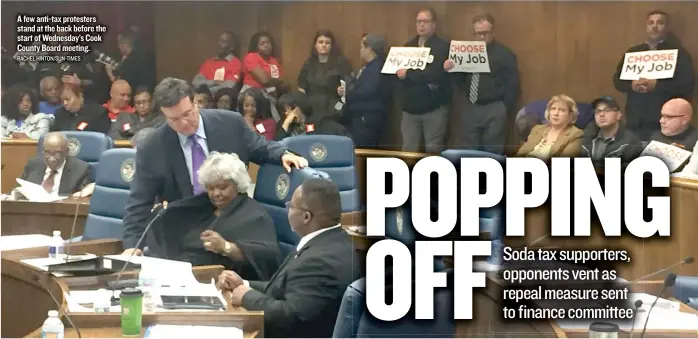  ??  ?? A few anti- tax protesters stand at the back before the start of Wednesday’s Cook County Board meeting. RACHEL HINTON/ SUN- TIMES