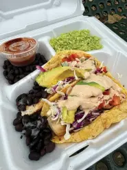  ?? (The Sentinel-Record/Bryan Rice) ?? Taco Mama fish tacos with fresh avocado slices, black beans and cilantro rice Nov. 16 at. This Takeout Takeaway was on location at the Hot Springs Farmers Market.