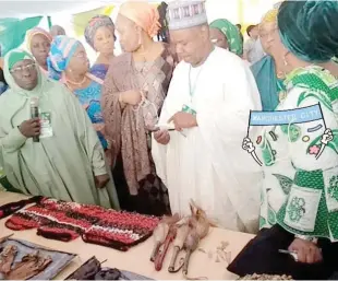  ??  ?? The Co-chair, National Food Security Council, Governor of Kebbi State, Abubakar Atiku Bagudu with the National president, NCWS, Mrs Laraba Shoda and others at the 2nd National Unity Food Fair yesterday in Abuja.