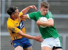  ??  ?? TIGHT GRIP: Limerick’s Cillian Fahy holds off Gordon Kelly of Clare