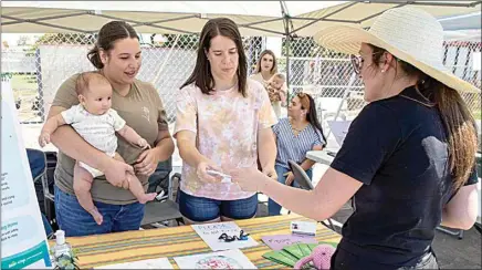  ?? PHOTOS BY ROD THORNBURG / FOR THE CALIFORNIA­N ?? Felicity Fuentes, a postpartum doula, and Aria Brigid Randle maintain a booth at the Maternal Health Fair held Saturday.