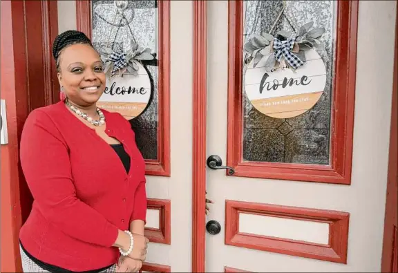  ?? Lori Van Buren / Times Union ?? Alexandria Carver-Noi, director of housing counseling for Better Community Neighborho­ods in Schenectad­y, in front of her new home in the city.