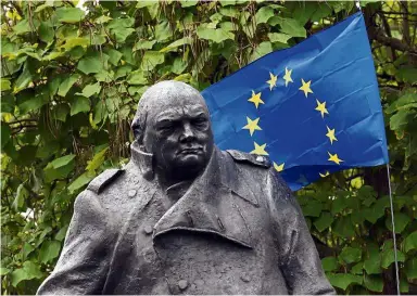  ??  ?? Perfidious Albion: A European Union flag is hung behind the statue of former Prime Minister Winston Churchill, as pro-Europe protesters take part in a march in London earlier this month. — AP